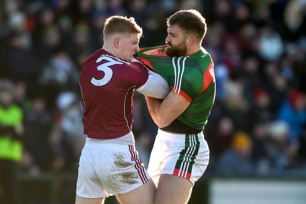 Galway player grabbing the short of a Mayo forward