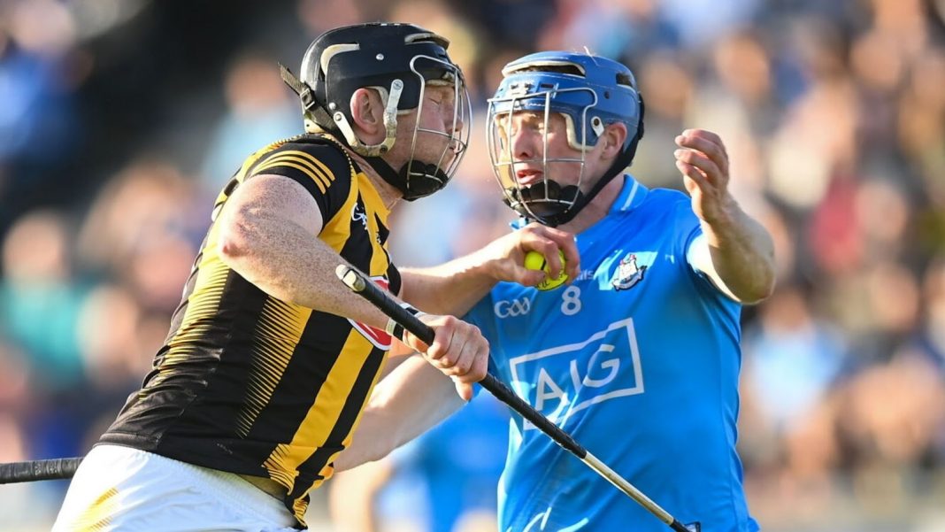 A Kilkenny hurler muscles a Dublin player out of the way