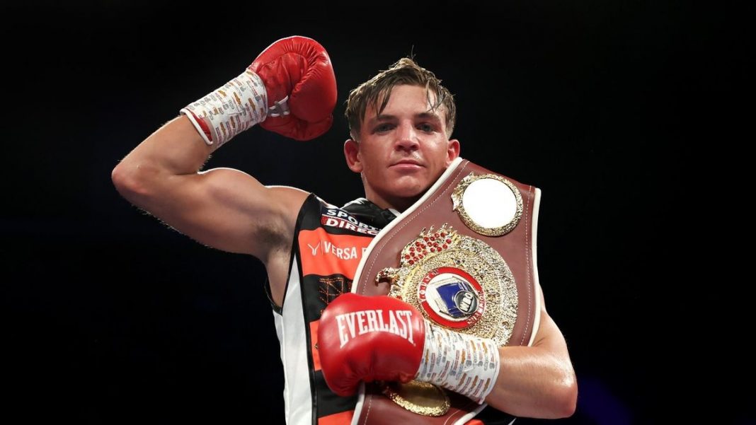 Dennis McCann celebrating a win with a belt over his shoulder