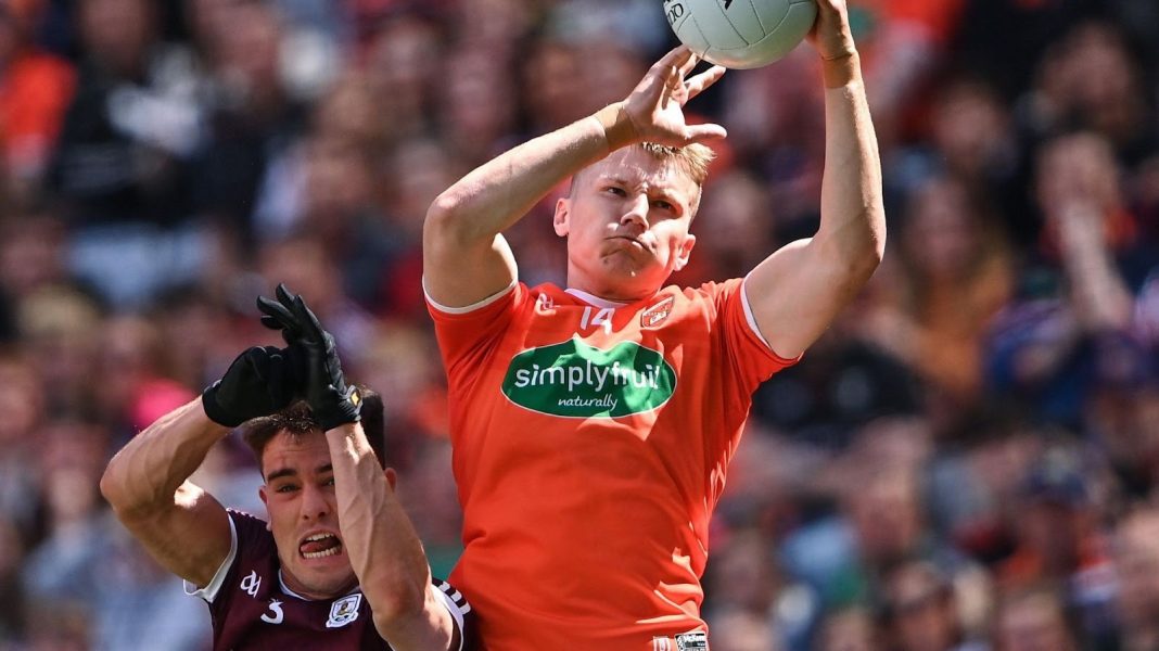 Armagh player jumping for a Gaelic football