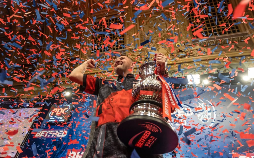 Nathan Aspinall lifts the 2023 World Matchplay trophy.