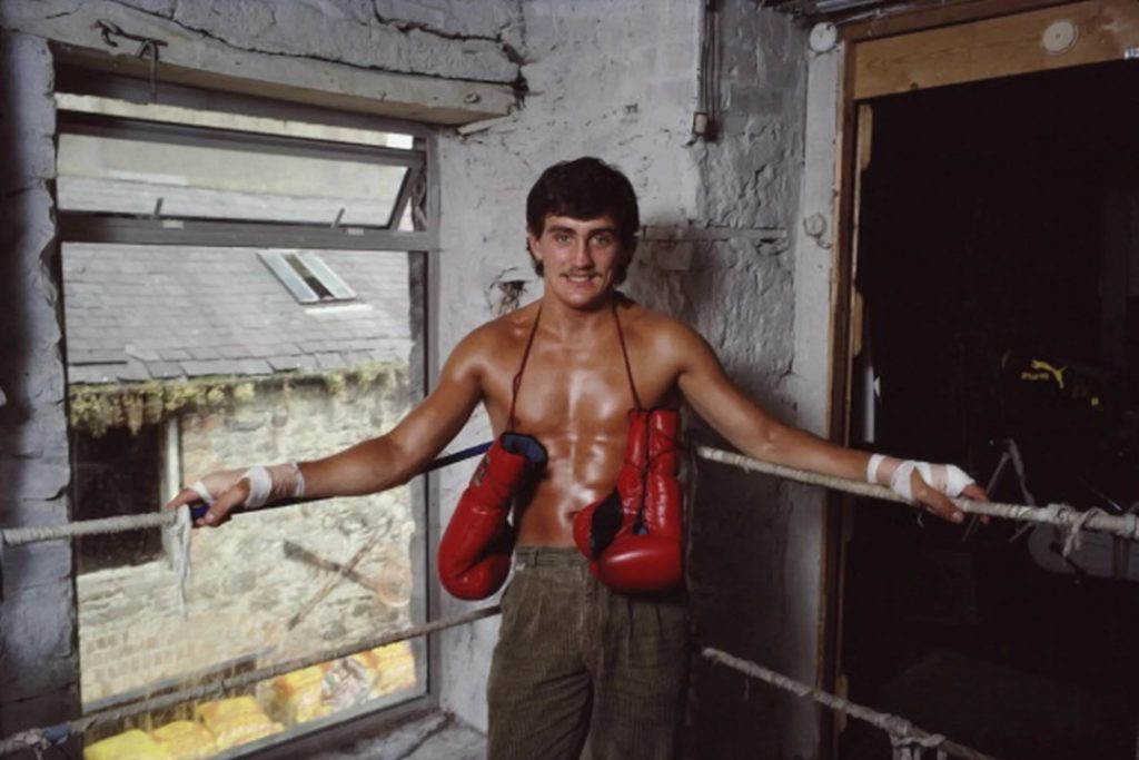 A young Barry McGuigan posing in his old gym