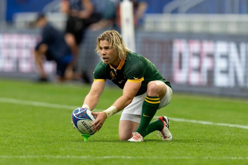 A photo of Faf de Klerk lining up a kick during a rugby match