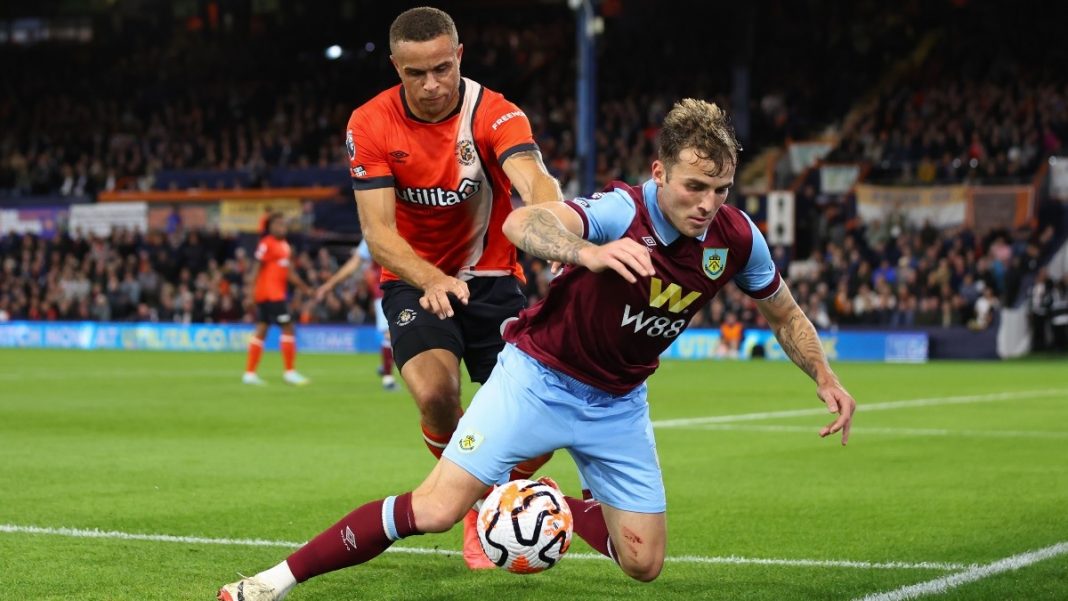 Luton Town player pushing a Burnley defender