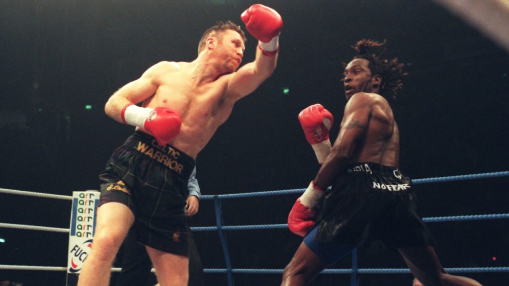 Steve Collins swinging a punch at rival Nigel Benn