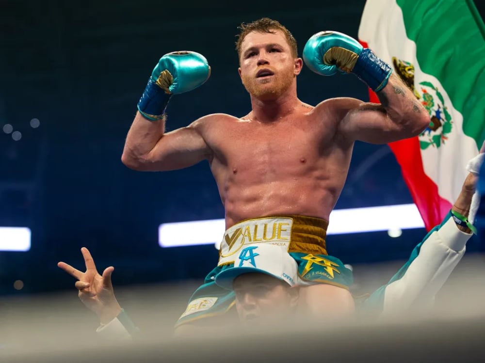 Canelo Alvarez celebrating a win in the ring.