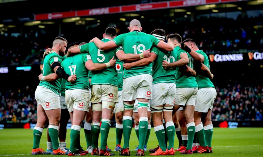 The Irish rugby team in a huddle before a game.