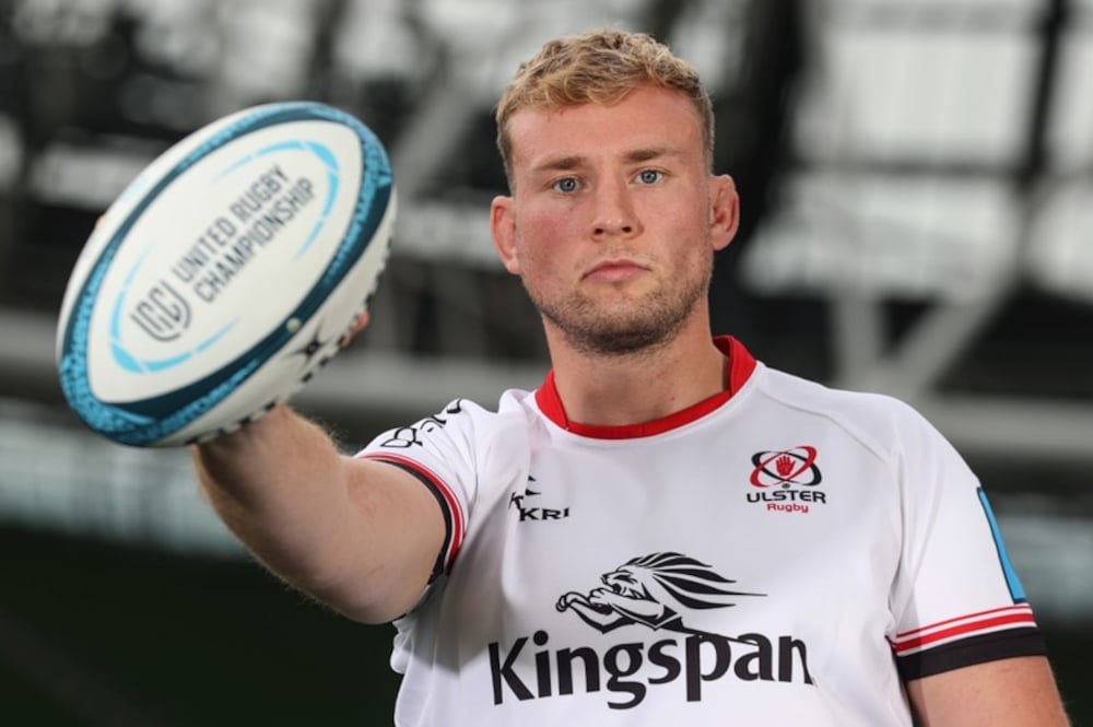 An Ulster player holding a rugby ball