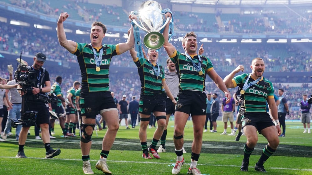 Northampton Saints players celebrating their title win on the field.